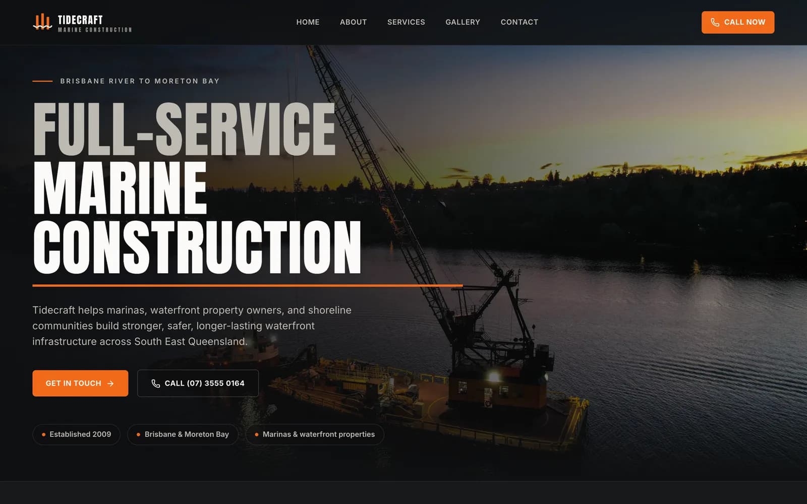 Tidecraft Marine Construction homepage hero — bold condensed headline over a dusk aerial of a crane barge on the Brisbane River